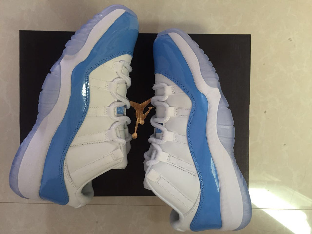 Jordan 11 Low Sneakers in White and University Blue