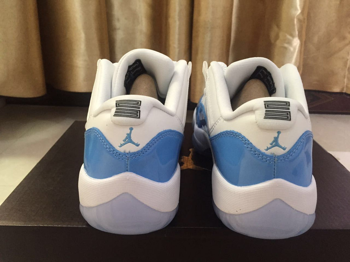 Jordan 11 Low Sneakers in White and University Blue