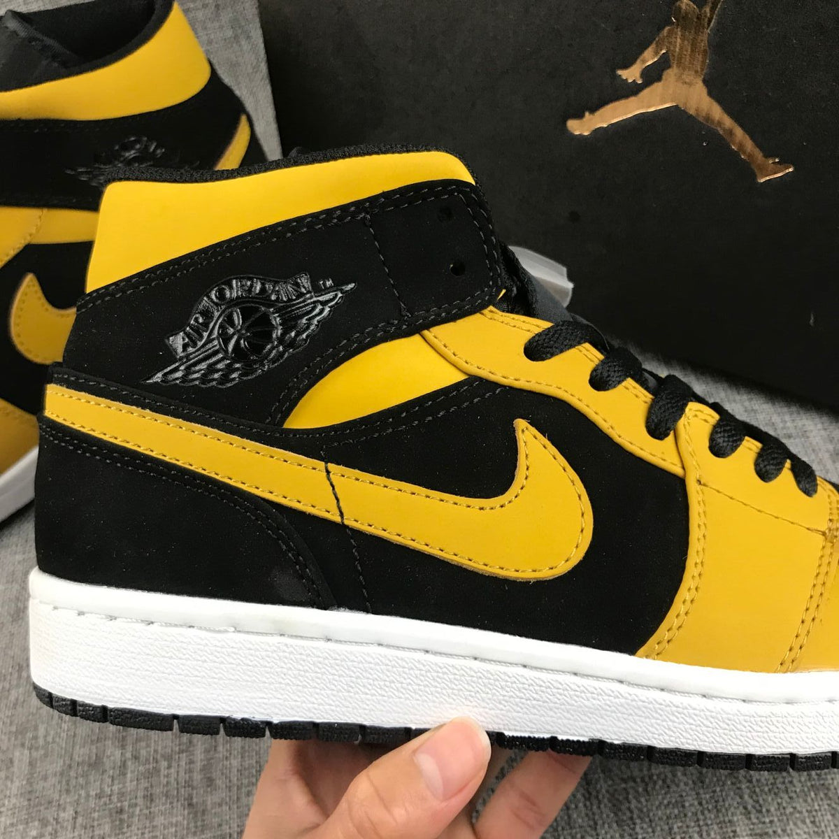 Air Jordan 1 Mid Black and Yellow Sneakers